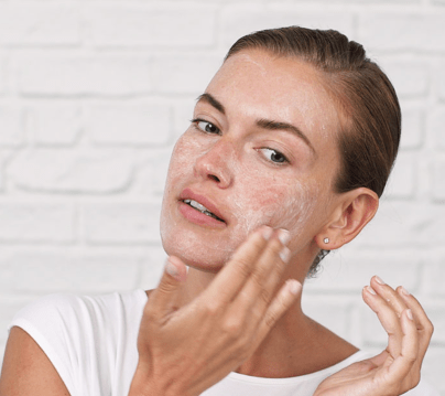 Woman Using Makeup Remover And Cleanser