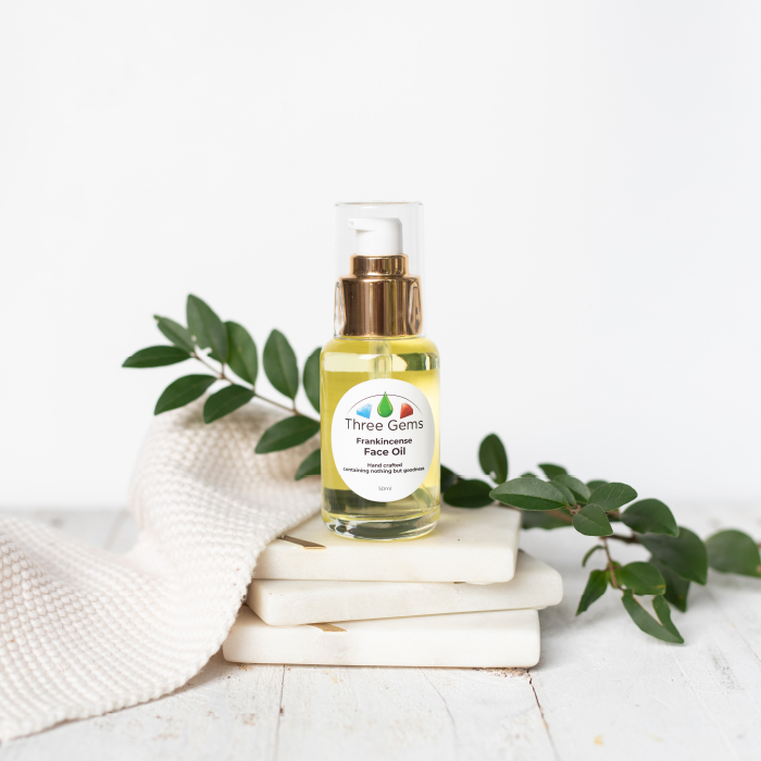 three-gems-face-oil-2 Three Gems Frankincense Face Oil on tiles with greenery