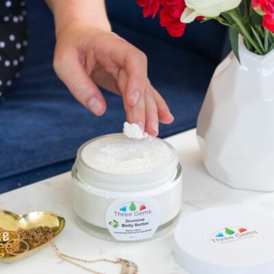 A Lady Using The Three Gems Organic Body Butter