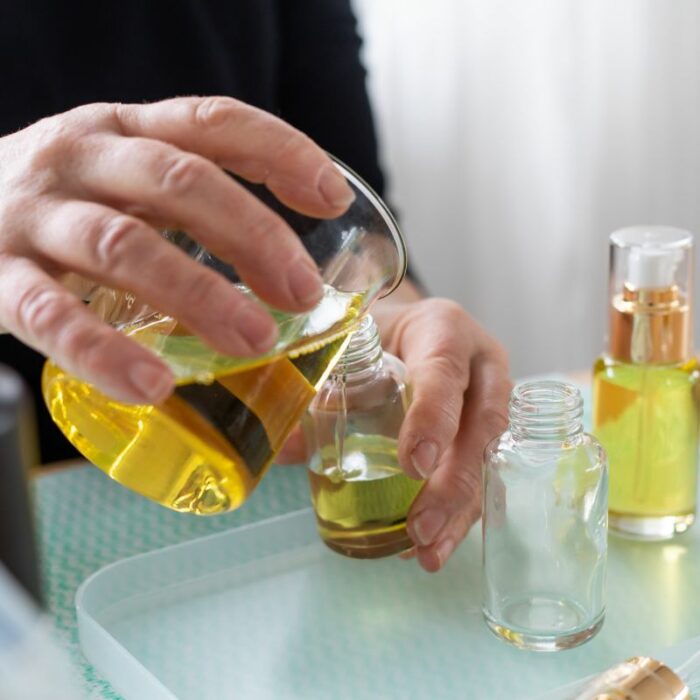 Three Gems Natural Skincare organic face oil being poured in to bottles