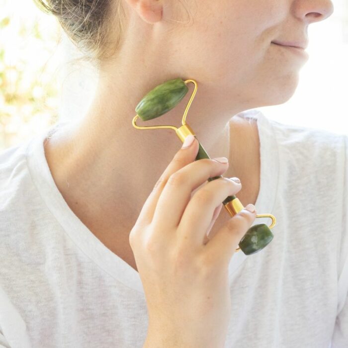 A lady using the Three Gems quality jade roller