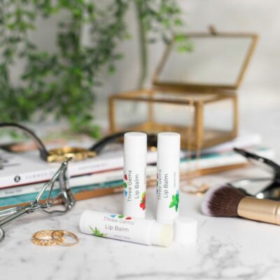 3 Of The Three Gems Natural Lip Balms On A Dressing Table