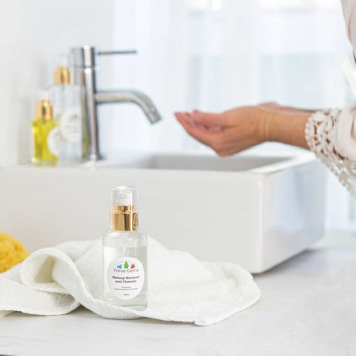 Three Gems Makeup Remover and Cleanser being used at a bathroom sink