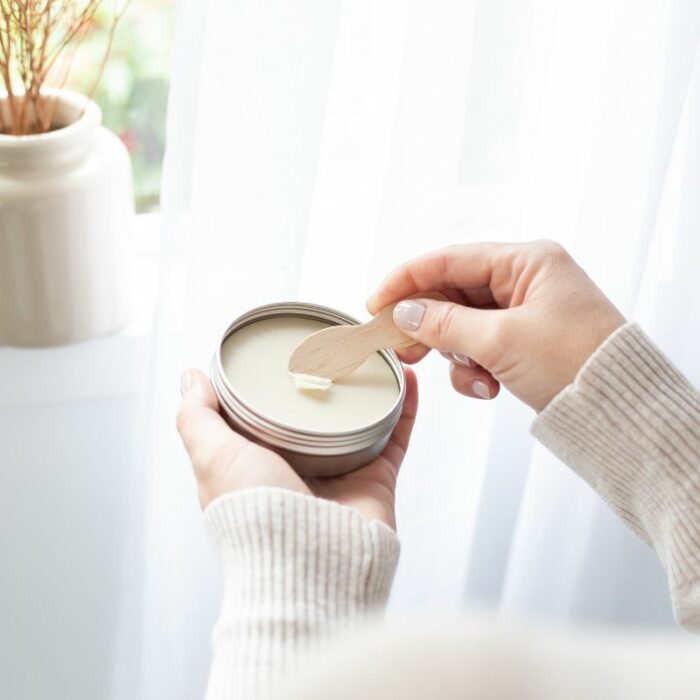 An open tin of the Three Gems Natural Deodorant showing the product and applicator